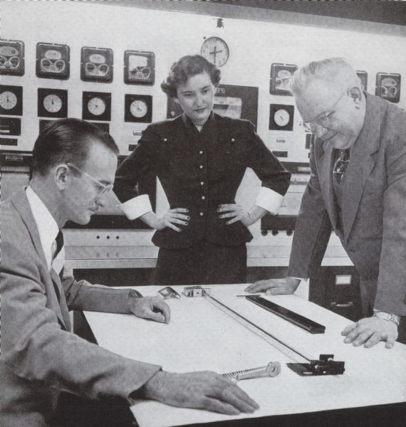 Mae Houston discussing foot pedal design of the Decorator with Ray Edwards and M. Jura of Experimental and Test.