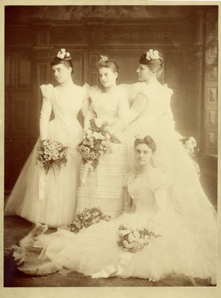 Group portrait of four women in front of a painted backdrop. Original caption reads: "Elizabeth King (left), possibly Katherine Isham,---, and Anita McC [McCormick], bridesmaids perhaps at Lucy McC's [McCormick] wedding, 1888. Max Platz, Photographer, 88 N. Clark St. Chicago."