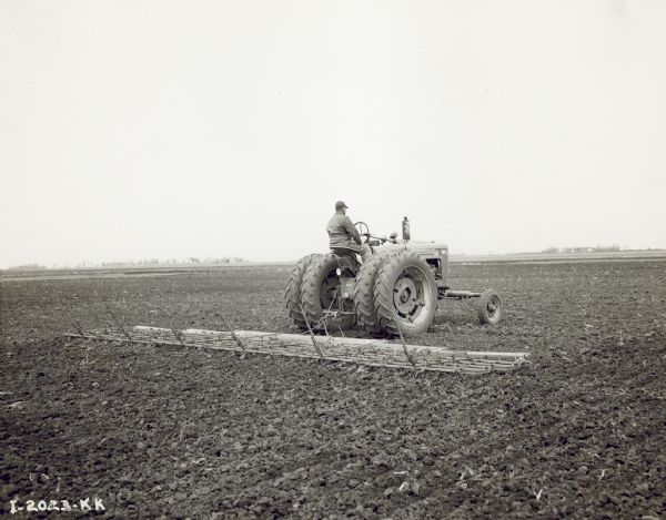 Farmall M With 6-section Peg-tooth Harrow 