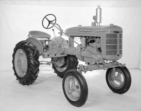 Three-quarter view from front of right side of a Farmall A Culti-Vision. There is a white backdrop in the background.