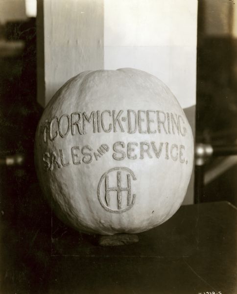 A squash with an engraved sign that reads: "McCormick-Deering Sales and Service. IHC."