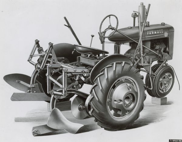 Illustration of a three-quarter view from right rear of a Farmall B tractor with plow attachment.