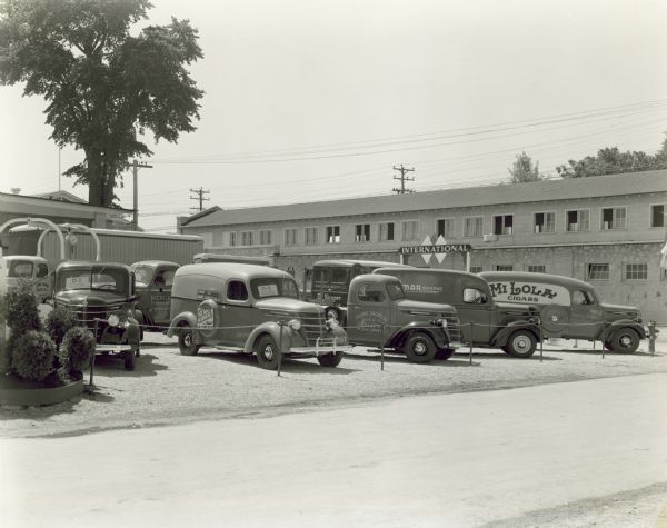 View of a group of International Motor trucks on display outdoors at the Wisconsin State Fair. Every truck in the display was sold to a customer and lettered and painted according to the owners specifications.
