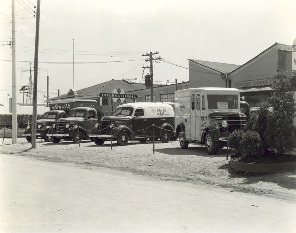 View of a group of International Harvester trucks on display outdoors at the Wisconsin State Fair. Every truck in the display was sold to a customer and lettered and painted according to the owners specifications.