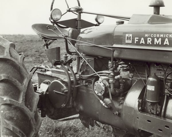 Farmall M tractor and 8 foot No. 10A disk harrow equipped with remote control hydraulic cylinder.