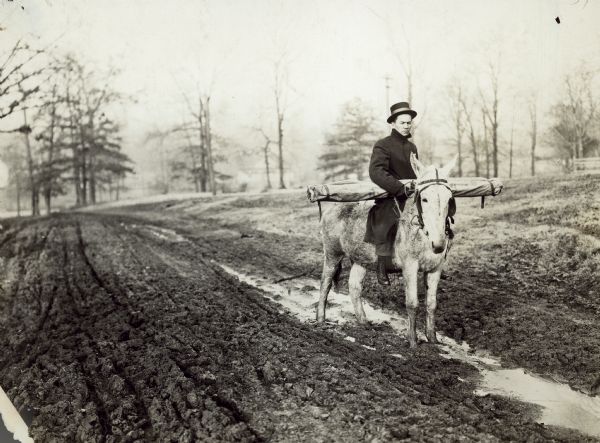 Dr. F.A. Wolfe making one of his speaking engagements on mule back, taking his chart with him as shown, after the road became so impassable that a team and buggy he was using could not get through.