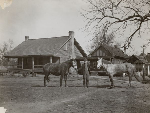 Walker Lee Dunson, his Prize horses and his home near Alexander City, Alabama. Walker is 15-years-old and goes to school, yet he holds the world's record as a corn grower on a single acre. In 1913 he produced 232 bushels of corn on an acre of ground.
