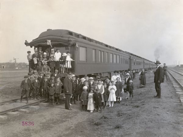 Group portrait of school children standing on and near the train for the Union Pacific Nebraska Preparedness Special Campaign.