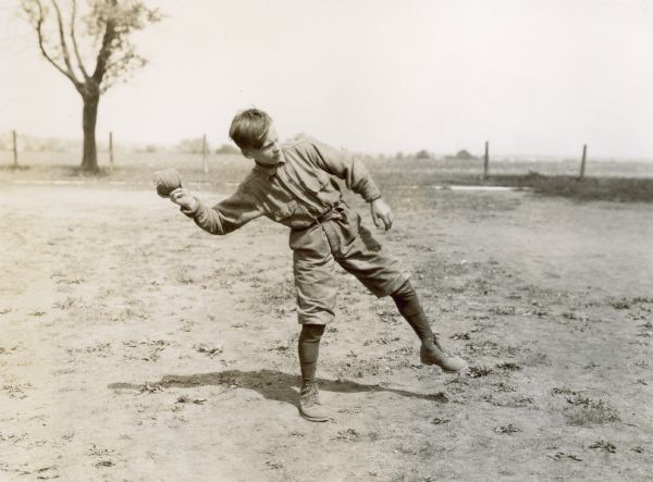 Young boy throwing a ball on the grounds of the Viall School, Cook County, Illinois.