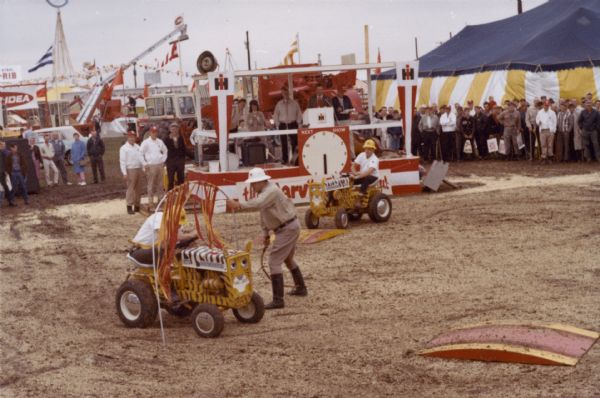 Men with Cub Cadet's performing at International Harvester's Fearless Fisbee, subject of a July 1966 "Harvester World" article. IH's "wild animal act" was designed to promote Cub Cadet sales.