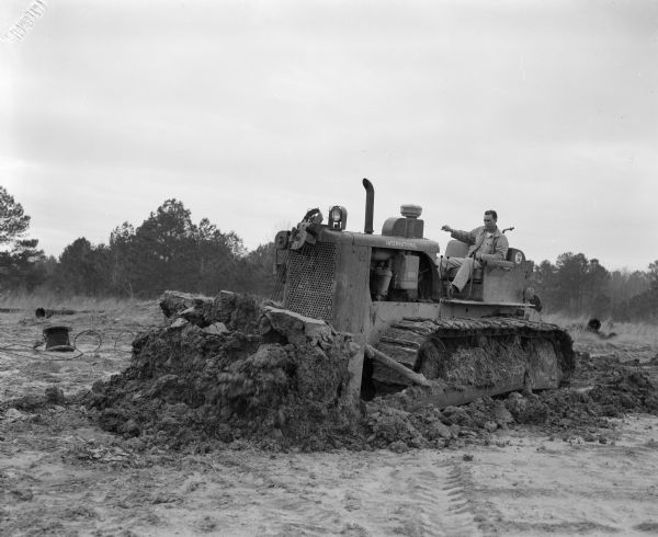 Man operating a TD-20 with Bulldozer blade.