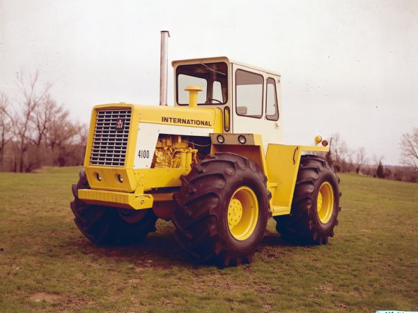 Three-quarter view from front left of an International 4100 parked outdoors on a lawn.