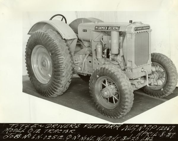 Three-quarter view from front right of a O-12 [Orchard 12] tractor. Original caption reads: "Title Drivers Platform Model O-12 Tractor. Job No. 6N-02512, Q No. None, Weight 3420 LBS. Neg. No. G.P. 12067. April 8-37."