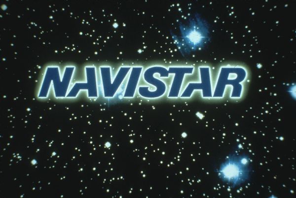 "Navistar" logo against a background of stars in a dark sky.