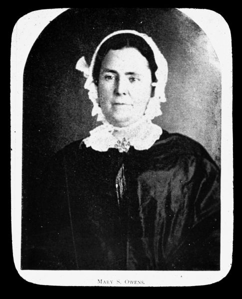 Waist-up portrait of Mary S. Owens. She is wearing a lace collar with collar pin, and a bonnet. Lantern slide.