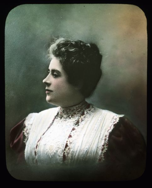 Quarter-length portrait of a woman. Hand-tinted lantern slide.