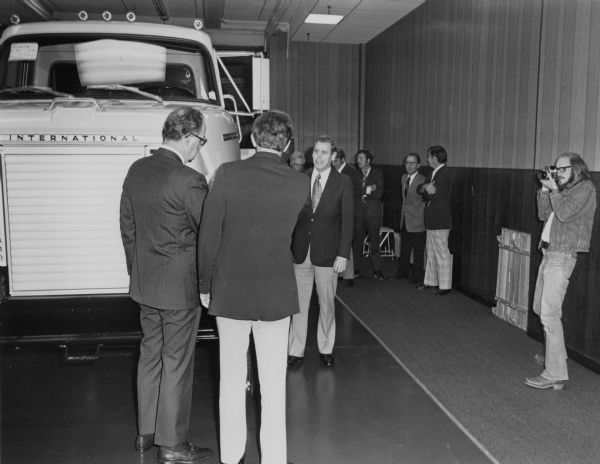 News Photo caption reads: "Local newspapers and TV news cameramen reported on the official opening of International Harvester's new Customer Review Center at its Ft. Wayne, Indiana truck manufacturing facilities. Here, plant manager R.H. Meyer is interviewed prior to the inspection of a new International Fleetstar medium-heavy-duty truck, one of 50 ordered by the state of North Carolina's Department of Transportation."