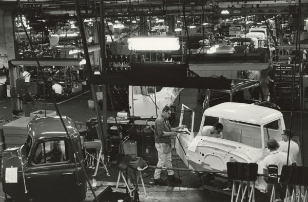 Elevated view of men working on factory floor.