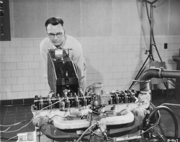 A man is using equipment to test an engine.