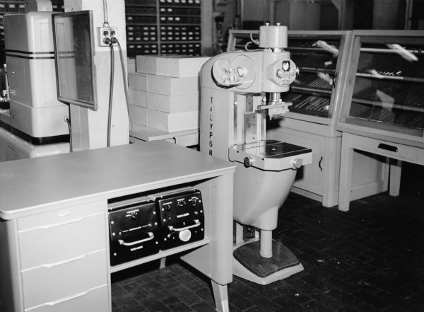 View of equipment in a room. Caption reads: "Talyrond Roundness Inspection Equipment."