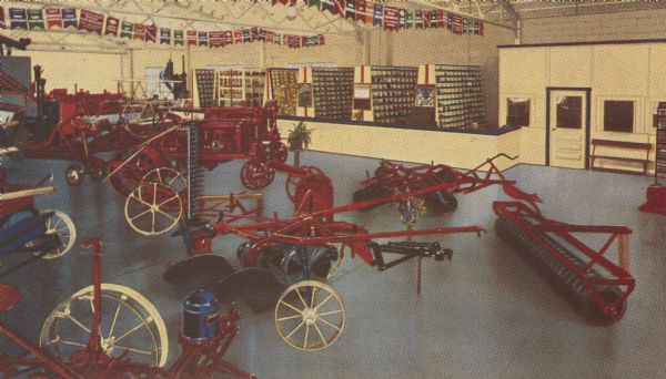Interior view from the southeast corner of Eilert's Farm Equipment company showing a floor display of farm machinery.