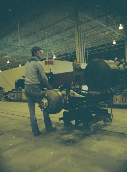 Interior view of a man working with machinery.
