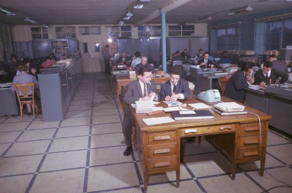 Men and women working in an office space in France.