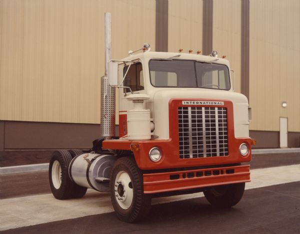 Three-quarter view toward front and right side of the International Transtar Conco 4170 semi. A large building is in the background.