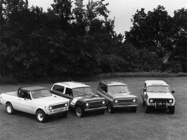 Slightly elevated view of four vehicles parked on a lawn. News Photo sheet reads: "The 1979 International Scout family of sports/utility Vehicles for 1979 includes (from left): The Scout Terra, a pickup with a six-foot bed on a 118-in. wheelbase; the Scout Traveler, a 118-in. wheelbase hatchback wagon; the Scout II, a 100-in. wheelbase vehicle with a full steel top; and the Scout SS-II, a performance-oriented open-top model on a 100-in. wheelbase."