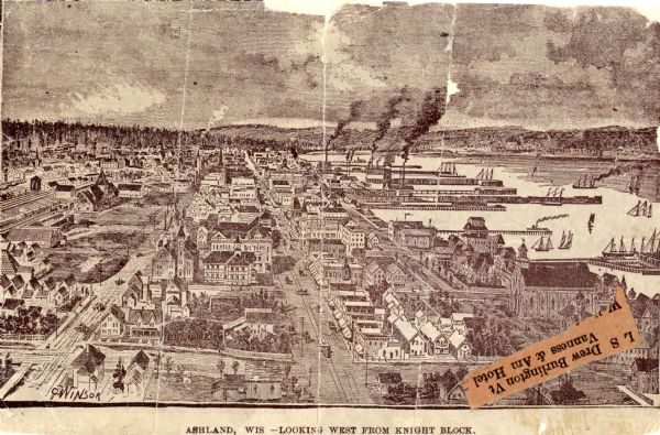 Looking West from Knight Block, with shipping piers and sailing ships on right side, railroad on left, trees in background. Horse-drawn carriages on streets, with horse-drawn trolley and tracks on street on right. Large church at bottom right, just above attached type reading "L S Drew Burlington, VT / Vaness and Am Hotel,"