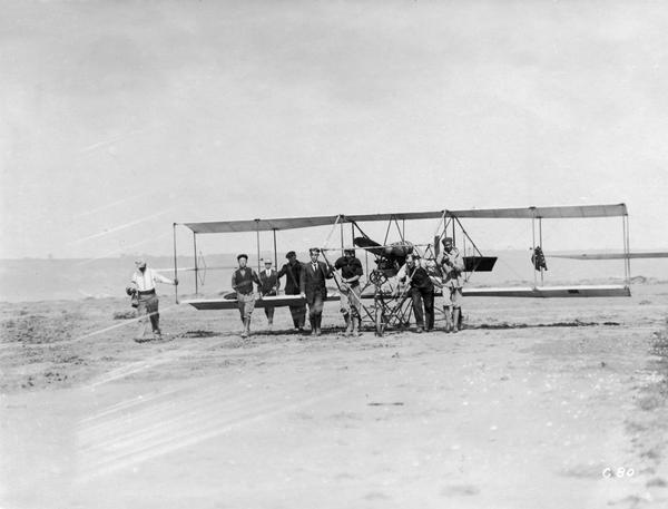 Students of the Curtiss School of Aviation on North Island moving a plane into position for a lesson.  
