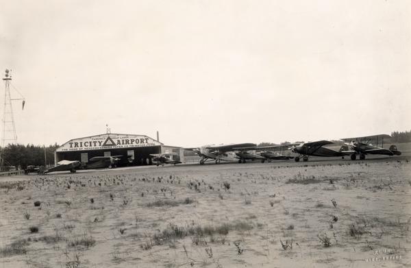 The Tri City Airport which served Wisconsin Rapids, Port Edwards, and Nekoosa, was organized in 1928 after the Nekoosa-Edwards Paper Company decided to purchase a corporate airplane. The Ford Tri-Motor that they bought is in the center of the photograph, together with other planes used for instruction by the Tri-City Flying School.