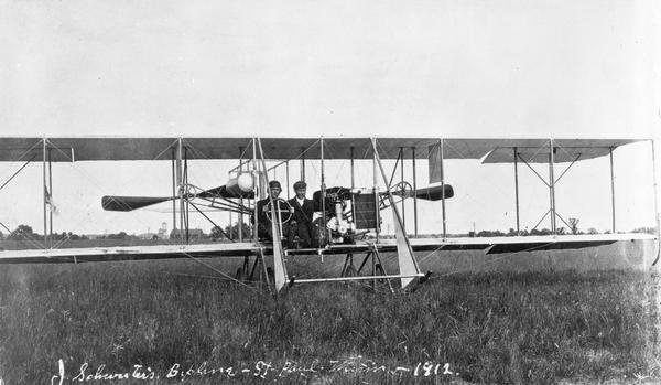 John Schwister at the controls of the "Minnesota-Badger," the plane he built in St. Paul, Minnesota and Wausau, Wisconsin. The passenger beside Schwister is unidentified.