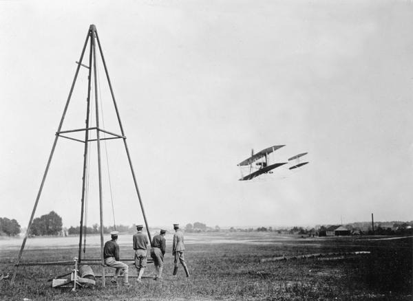 Soldiers at Fort Myer, Virginia, watching Orville Wright demonstrate the Wright Brothers' airplane for the U.S. Army. Milwaukee's Billy Mitchell is said to have attended this test as a young Signal Corps officer. This is what he would have witnessed. Mitchell was the first person with Wisconsin ties to witness the Wright Brothers' plane in flight.