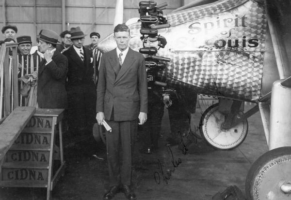 Charles Lindbergh in Paris, posed by the "Spirit of St. Louis," Ryan monoplane in which he flew solo across the Atlantic. Clearly visible is the plane's Curtiss Whirlwind engine. Although only faintly seen in the photograph, Lindbergh autographed the print for Leland Stowe, a journalist covering the story for the New York Herald Tribune. Stowe's collection is one of many collections about newspaper journalism available for research at the Wisconsin Historical Society Archives.