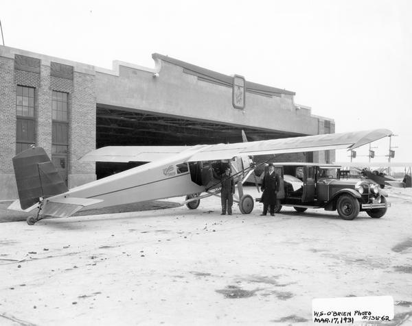 A scene at Curtiss-Wright Field in Milwaukee. Pictured are Arthur D. Gaspar, a Waukesha funeral director, and Paul Trier, the pilot of the Curtiss Thrush. The two men worked with the airport management to establish a pioneering ambulance service for the area.