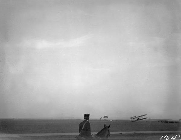 An Italian soldier on horseback watches Wilbur Wright land a Wright "Flyer" somewhere near Rome. After his triumphant demonstration of the "Flyer" in France in 1908, Wilbur Wright flew to Italy to demonstrate his airplane for the Italian Army. His arrival near Rome was witnessed by vacationing Milwaukee businessman Louis Allis who took this candid snapshot. It is likely that Allis was the second person with Wisconsin ties to see the Wright plane fly.