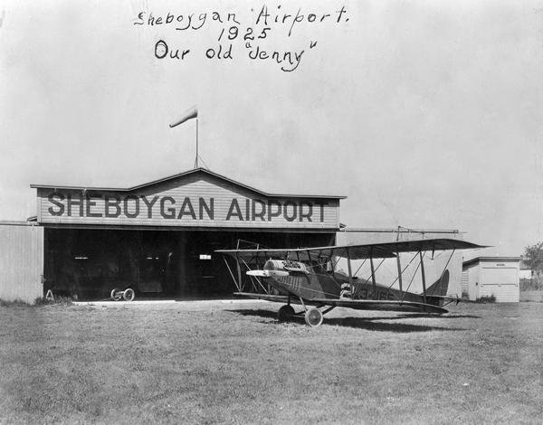The first Sheboygan Airport operated by Anton Brotz, Sr. Parked in front of the hangar is a Curtiss "Jenny," as the World War I-era Curtiss JN models were known.