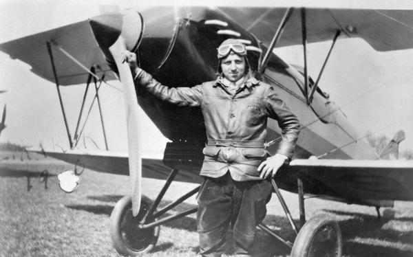 Pilot Louis Kakuk, manager of the Manitowoc Airport, with his Waco airplane. Kakuk's career followed a typical pattern for aviators, moving from the freewheeling existence of a barnstormer to the more settled life of an airport manager.