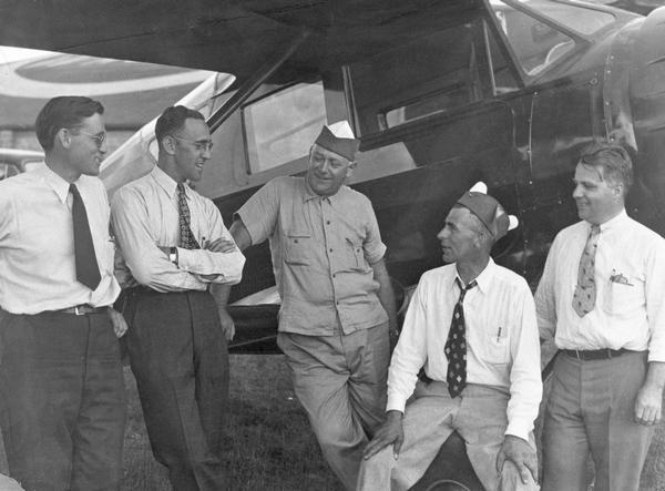 An unidentified photograph thought to be of a National Aeronautics Association cross-country flight. The identified individuals are Steve Wittman of Oshkosh (second from left), Archie Towell of Wausau (next left), and Freddie Haag of Antigo (at right end of row).