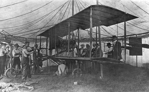 An exhibition airplane on display inside a tent at Dixon, Illinois, thought to be a "Red Devil," plane designed by Thomas A. Baldwin.