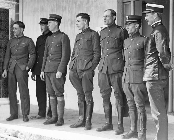 The crew of NC-4 during their interim stop in the Azores: Left to right: Lt. Elmer Stone, Eugene Rhoades (machinists mate), Lt. Walter Hinton, Ensign H.C. Rodd, Lt. J.G. Breese, Lt. Commander A.C. Read, and Captain Jackson of the base ship Melville. The NC-4 successfully completed the first trans-Atlantic flight to Lisbon in 24 days.