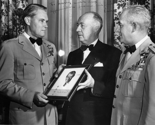 Aviation publicist Harry Bruno flanked by two Air Force generals with Wisconsin ties who played a prominent role in shaping post-World War II air defense policy: Hoyt Vandenberg (who was born in Milwaukee) and Nathan F. Twining (originally from Monroe). Vandenberg is presenting an autographed photograph to Bruno.