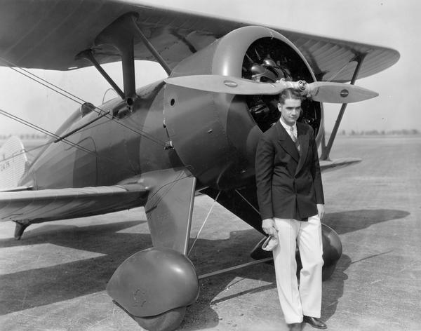 Howard Hughes, looking every inch the millionaire playboy, with his U.S. Army Boeing pursuit plane. Hughes had rebuilt the plane in order to increase its speed, and in 1934, he set a new national record.