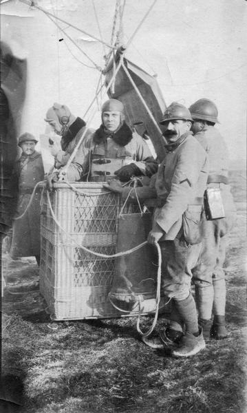 The gondola crew of a World War I observation balloon that is about to ascend. Observation balloons were positioned near the front so that men in the gondola could observe troop movements and calculate artillery effectiveness.