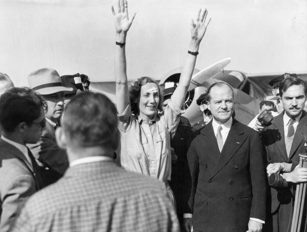 Beryl Markham, a former Kenyan bush pilot, waves to the crowd as she arrives at Floyd Bennett Field in New York. She had just completed the first solo east-to-west Atlantic crossing by a woman. To her left, in the hat, is her publicist, Harry Bruno. Bruno's papers are one of many mass communications collections in the Historical Society Archives.