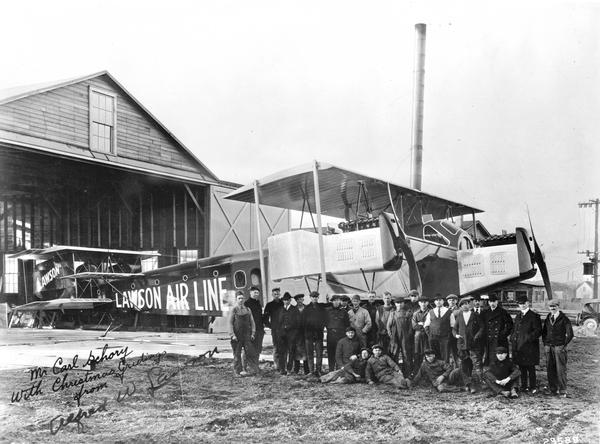 Alfred W. Lawson (second from right) and his employees in front of his South Milwaukee factory with the center section of his new airplane, the Lawson Midnight Airliner L-4. Lawson designed and built several large planes in Milwaukee after World War I and is said to have coined the name airliner because his planes were designed to carry a relatively large number of passengers. Lawson's first airliner successfully flew a 2000-mile demonstration trip to New York, Washington, D.C., and back to Milwaukee in 1919 carrying 15 passengers. His second plane, the Midnight Liner L-4, was even larger, with a wingspan of 117 feet. Powered by three Liberty engines, the L-4 was designed to carry 34 passengers with overnight accommodations. The L-4 plane crashed on its first takeoff attempt in 1921. This exhausted Lawson's financial resources in Milwaukee and virtually ended his career in aviation.