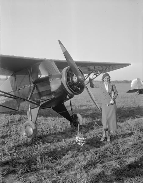 RKO motion picture actress Raquel Torres christening the new model airplane manufactured in Madison by Orland Corben. Corben had flown the airplane that brought Torres to Madison for an appearance at the Orpheum Theatre, and he probably arranged for her participation then.  The new plane was the Corben Junior Ace. (The use of soda pop rather than champagne for the christening was necessitated by Prohibition.)