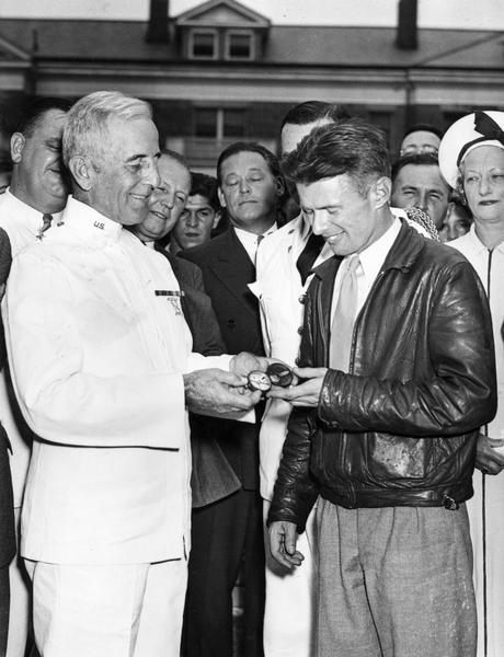 Douglas Corrigan examining a compass with General Evan Humphreys after Corrigan "mistakenly" flew from New York to Ireland. Corrigan claimed that he had read the compass incorrectly, and he never admitted that his trans-Atlantic flight was undertaken intentionally because he was unable to get official permission. After his flight, Corrigan returned to the United States as a folk hero, and his antics gave rise to the label "Wrong Way Corrigan."