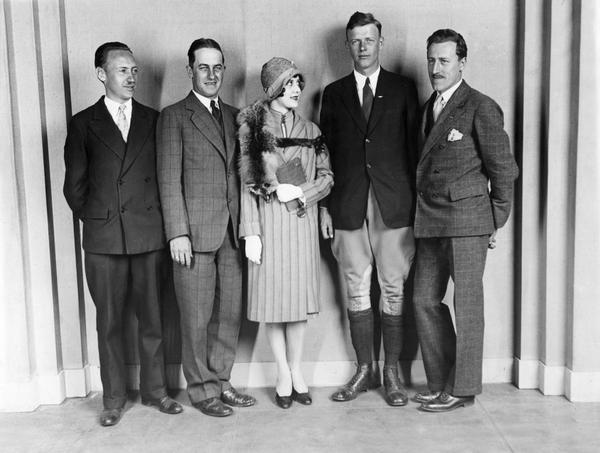 Publicist Harry Bruno; B.F. Mahoney, designer of "The Spirit of St. Louis"; an Earl Carroll chorus girl; Charles Lindbergh; and Bruno's partner, Richard Blythe, posing for a portrait shortly before Lindbergh took off for his trans-Atlantic flight.
